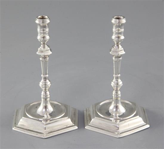 A pair of George V 19th century style cast silver tapersticks by Thomas Bradbury & Sons, Sheffield, 1929, 11.5cm.